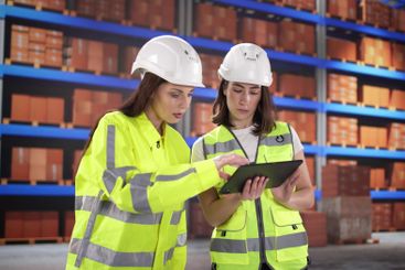 Female warehouse supervisor inspects inventory
