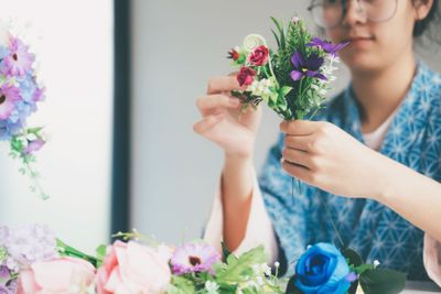 Female hands making beautiful flower composition in...