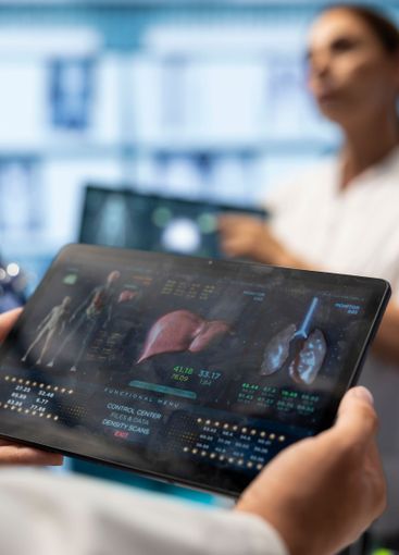 Medic expert analyzing ct scan result to examine organs...