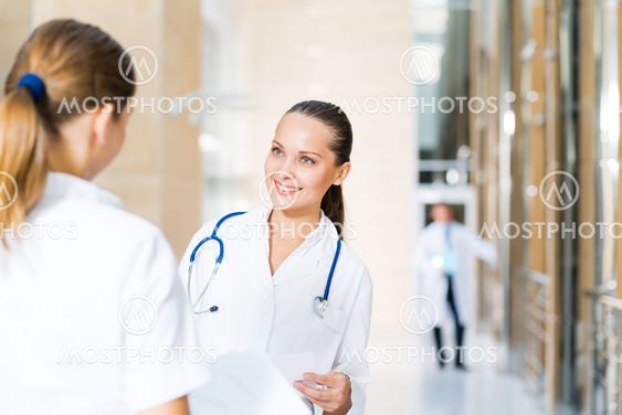 two doctors talking in the lobby of the hospital