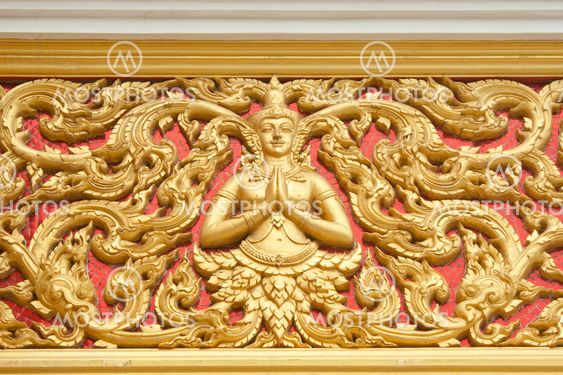 the gold stucco design of native thai style on the Wall