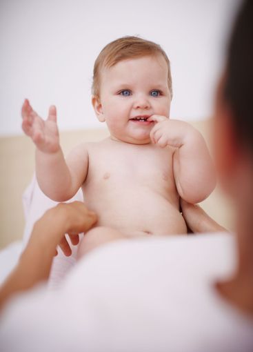 Baby, parent and teething with fingers in home, love and...