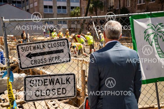 A man look at a street site under construction