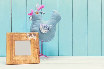 Cozy pastel wooden home decor objects on blue background