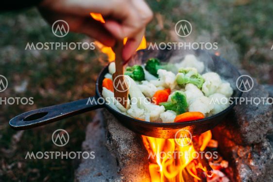 Cauliflower, broccoli and carrot in a pan. Cooking on an...