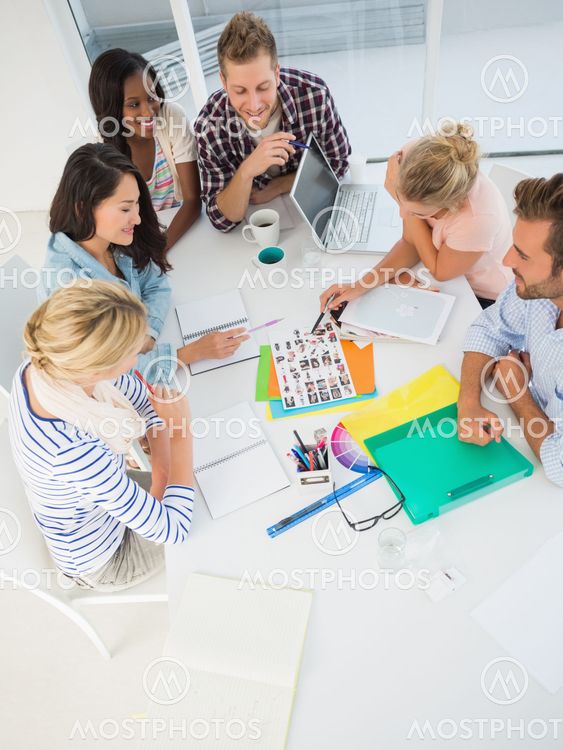 Young design team going over contact sheets together