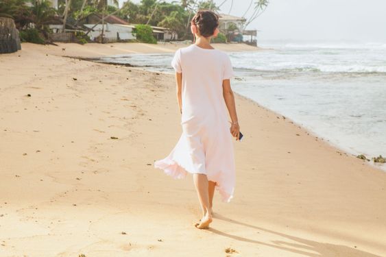 Woman walking on the beach sand