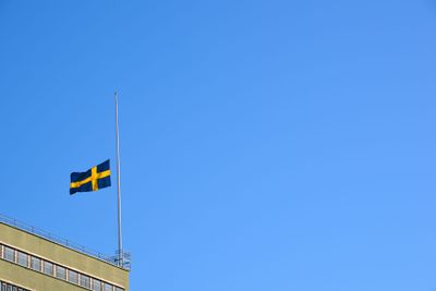 Swedish flag flying half mast