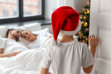 boy entering parent's bedroom in christmas morning