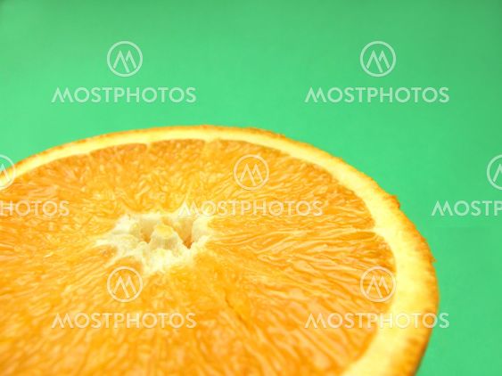 sliced orange macro on green background