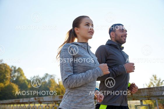 happy couple running outdoors