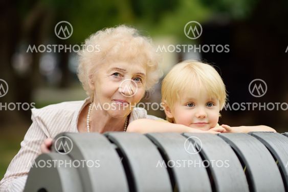 Beautiful granny and her little grandchild together in park