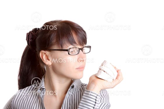 Woman and white plaster jaw model