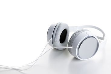 Pair of earphones close up on grey background