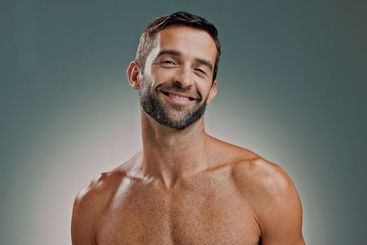 Portrait, skincare and happy man in studio for natural...