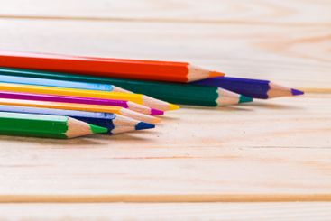 Colorful collection of sharpened pencils arranged on a...