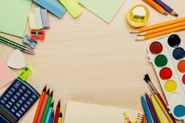 Colorful stationery and art supplies arranged on a...