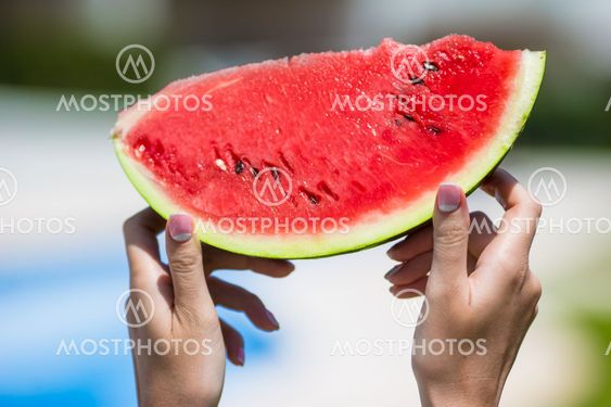 Closeup girl female hands with watermelon background...