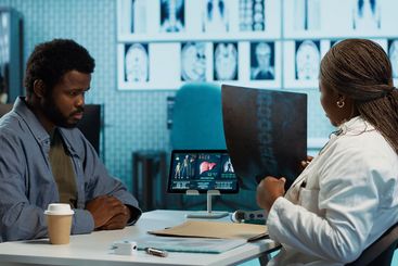 African american young man and specialist review ct...