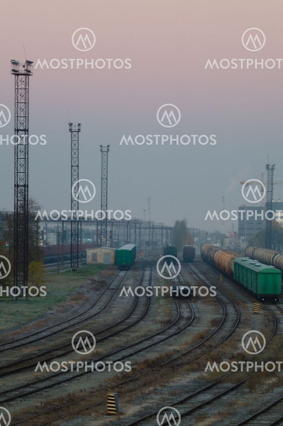 Cargo train platform with containers on early misty morning