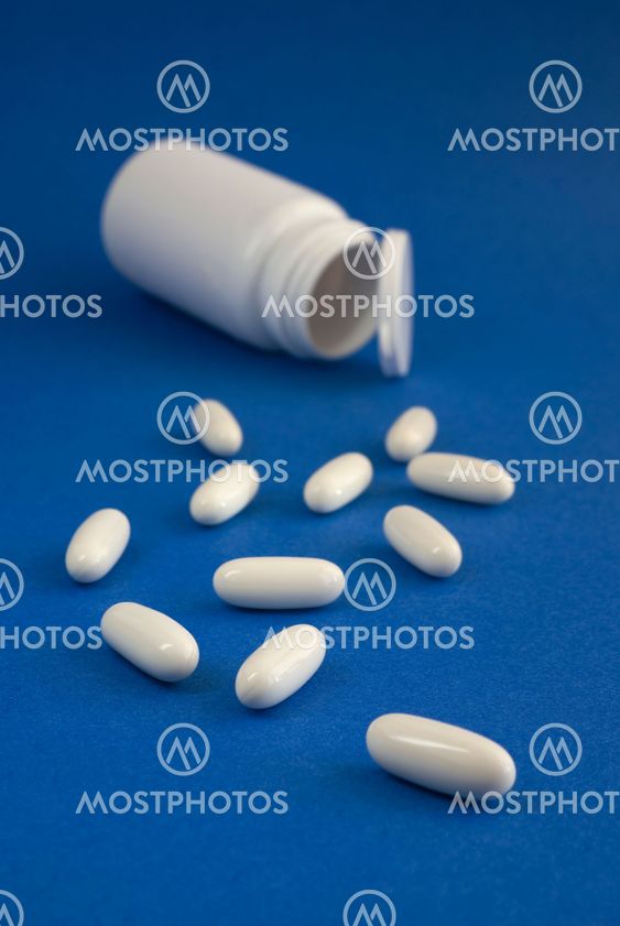 White pills on blue background