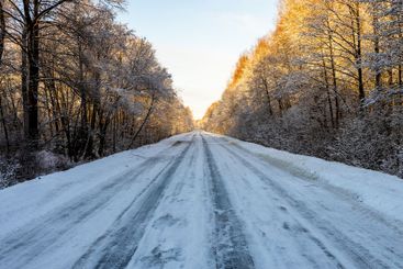 surface of slippery frozen road on winter evening