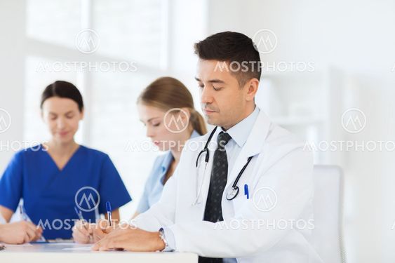 group of happy doctors meeting at hospital office
