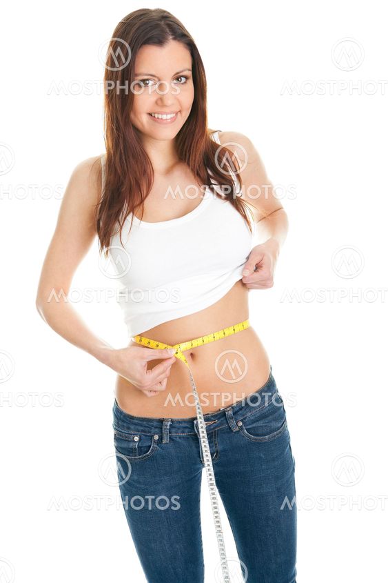 Beautiful woman measuring waist