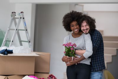 multiethnic couple moving into a new home