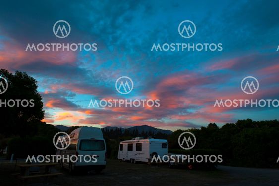 Campervan and caravan camping at Peketa Beach, Kaikoura, South Island of New Zealand, during sunset