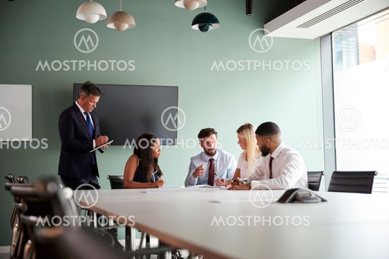 Group Meeting Around Table At Graduate Recruitment...