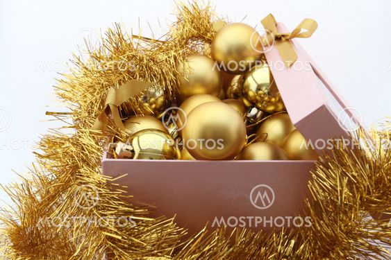 golden new year's balls to box on white background