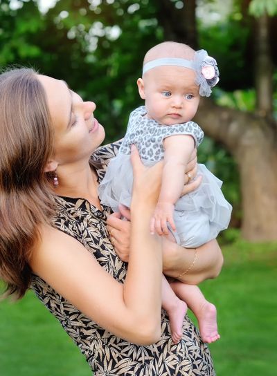 Happy mother and her little daughter in the summer field 