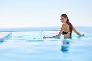Woman, portrait and relax in swimming pool, sky and...