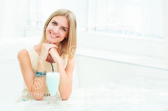 Portrait of a cute woman in a city cafe