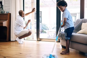 Cleaning, dad and son in home, smile and teaching of...