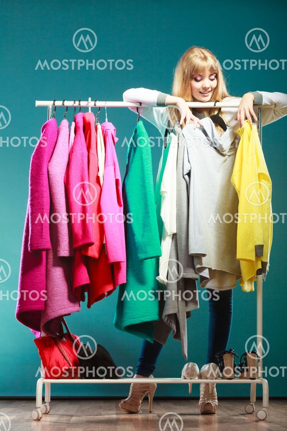 Woman choosing clothes to wear in mall or wardrobe