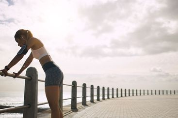 Seaside, woman and retired from running with fitness on...