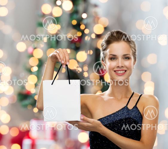 smiling woman with white blank shopping bag