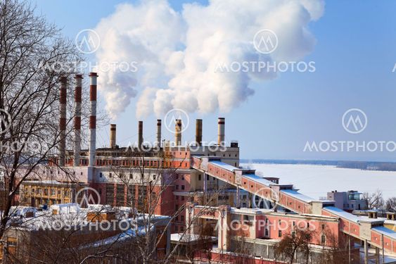 Large factory with smoking chimneys against the blue sky