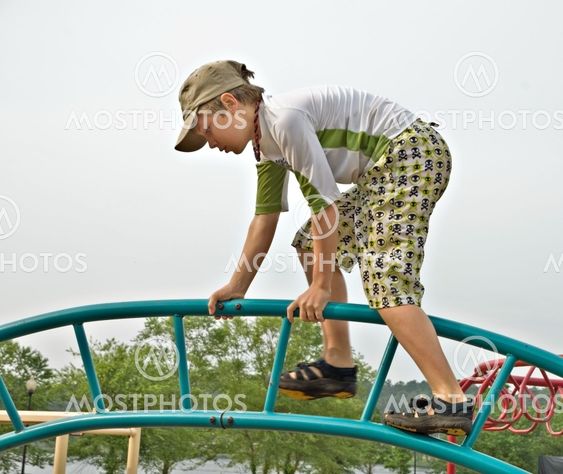 Young Boy Climbing in Park