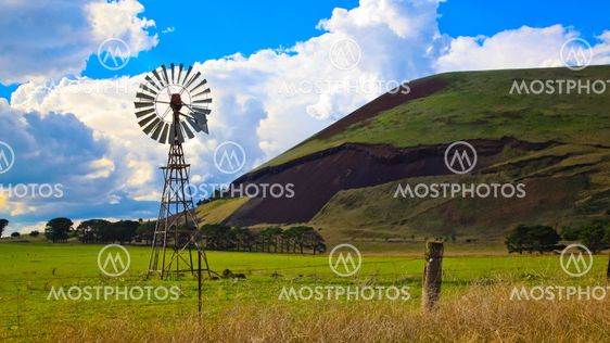 Windmill on a farm with volcanic mountain in the background