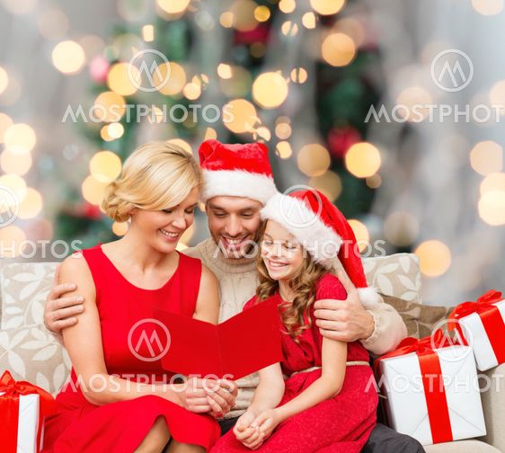happy family in santa helper hats with gift boxes
