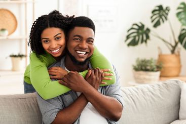 Happy Married Black Couple Cuddling At Home And Posing...