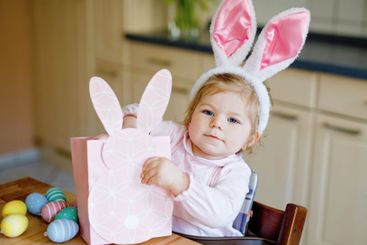 Cute little toddler girl wearing Easter bunny ears...