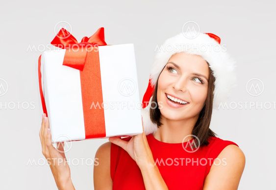 smiling woman in santa helper hat with gift box