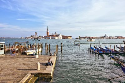 Daylight view to port with parked boats and couples...