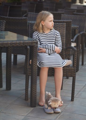 Cute child girl sitting indoor, portrait