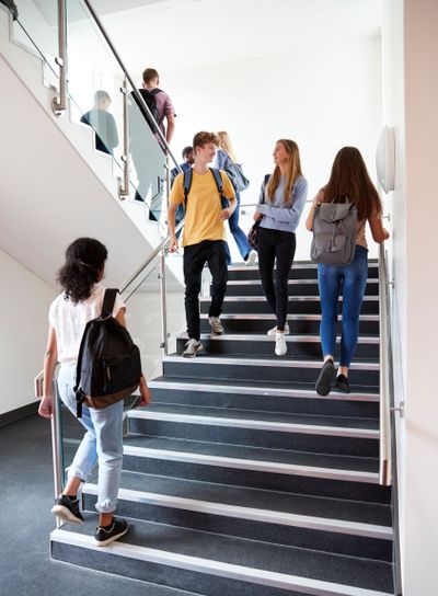High School Students Walking On Stairs Between Lessons In...