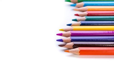 Colorful colored pencils arranged in a neat row for...